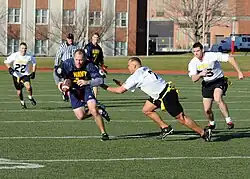 Photograph of men playing flag football