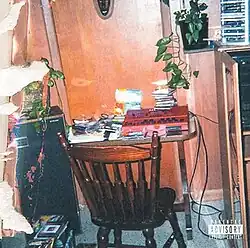 A photograph of a portion of Cole's old bedroom with a beat machine and several other items on a table